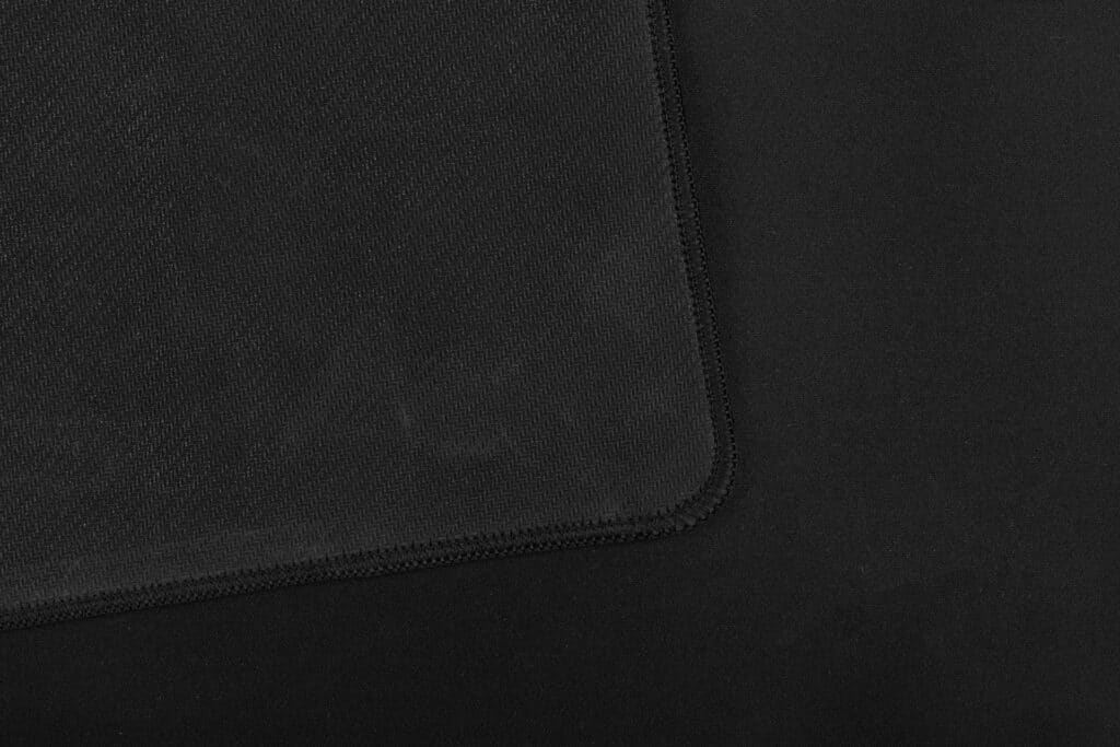 Texture of black fabric gaming mouse pad closeup