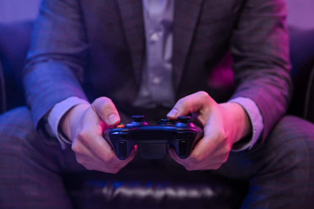 Elegant man holds gaming controller