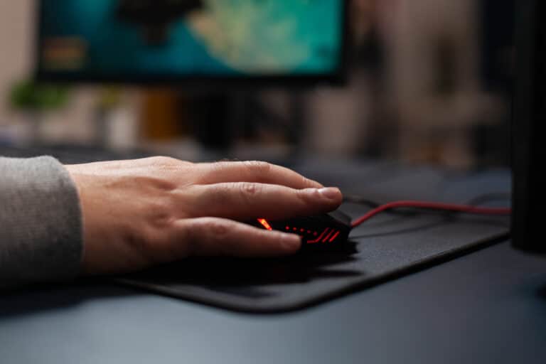 Close up of gamer holding mouse on mousepad